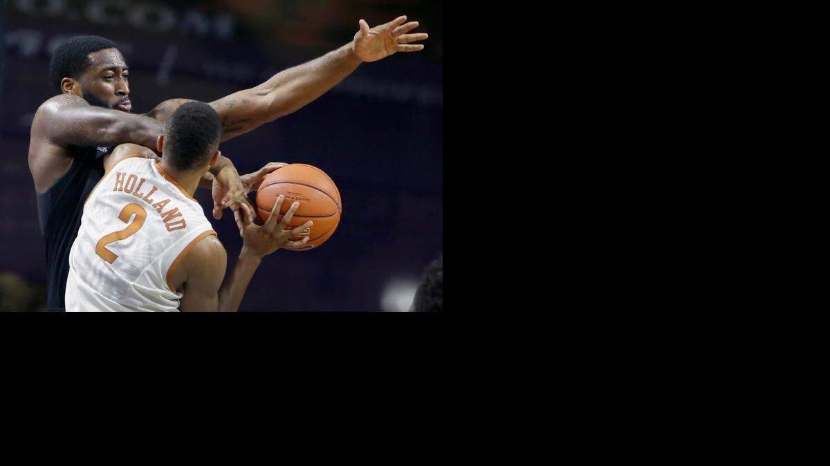 
Kansas State's Thomas Gipson tries to steal the ball from Texas' Demarcus Holland (2) during the second half of an NCAA college basketball game Saturday, Feb. 7, 2015, in Manhattan, Kan. Texas won 61-57. 
