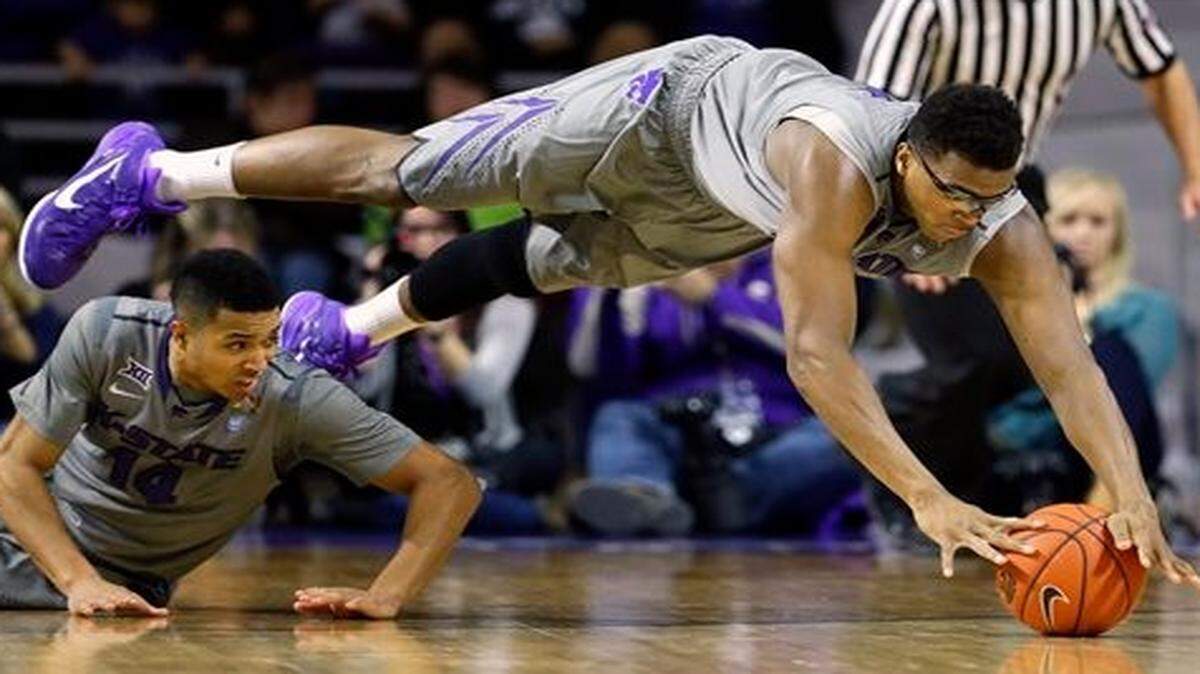 
Kansas State's Stephen Hurt (right) dives for a loose ball during the first half of Saturday basketball game against Baylor in Manhattan.
