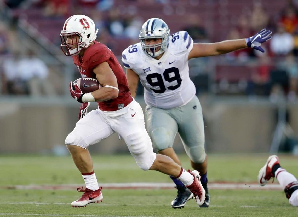 Stanford running back Christian McCaffrey (left) ran through and past the K-State defense for a 35-yard touchdown in the first half.