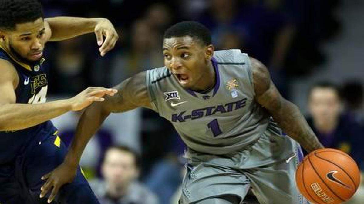 
Kansas State guard Jevon Thomas drove on West Virginia guard Gary Browne on Jan. 27 in Manhattan, Kan. West Virginia defeated Kansas State 65-59.
