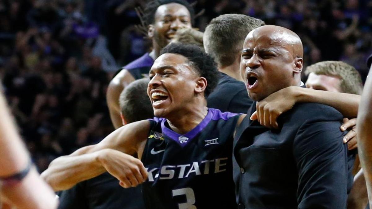 Kansas State’s Kamau Stokes (3) celebrated with assistant coach Chester Frazier after a 79-75 win against West Virginia at Bramlage Coliseum in Manhattan, Kan., on Jan. 21.