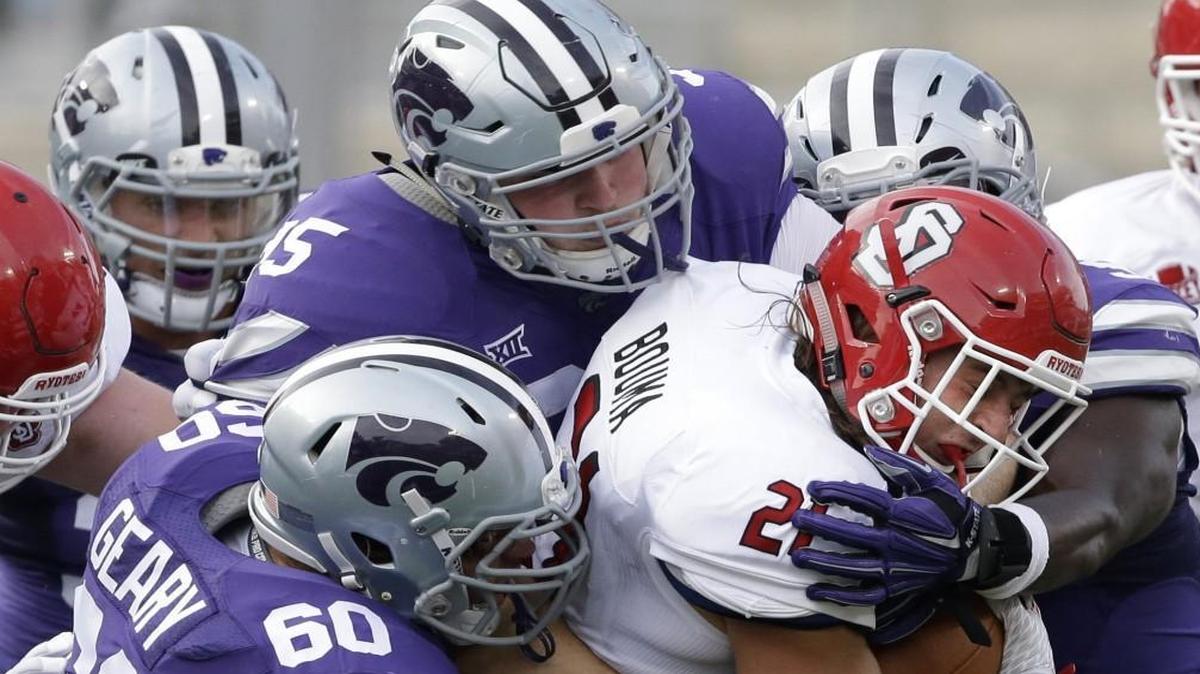 South Dakota running back Trevor Bouma was no match for the combined power of Kansas State defensive tackles Will Geary (left) and Travis Britz (middle) in September.