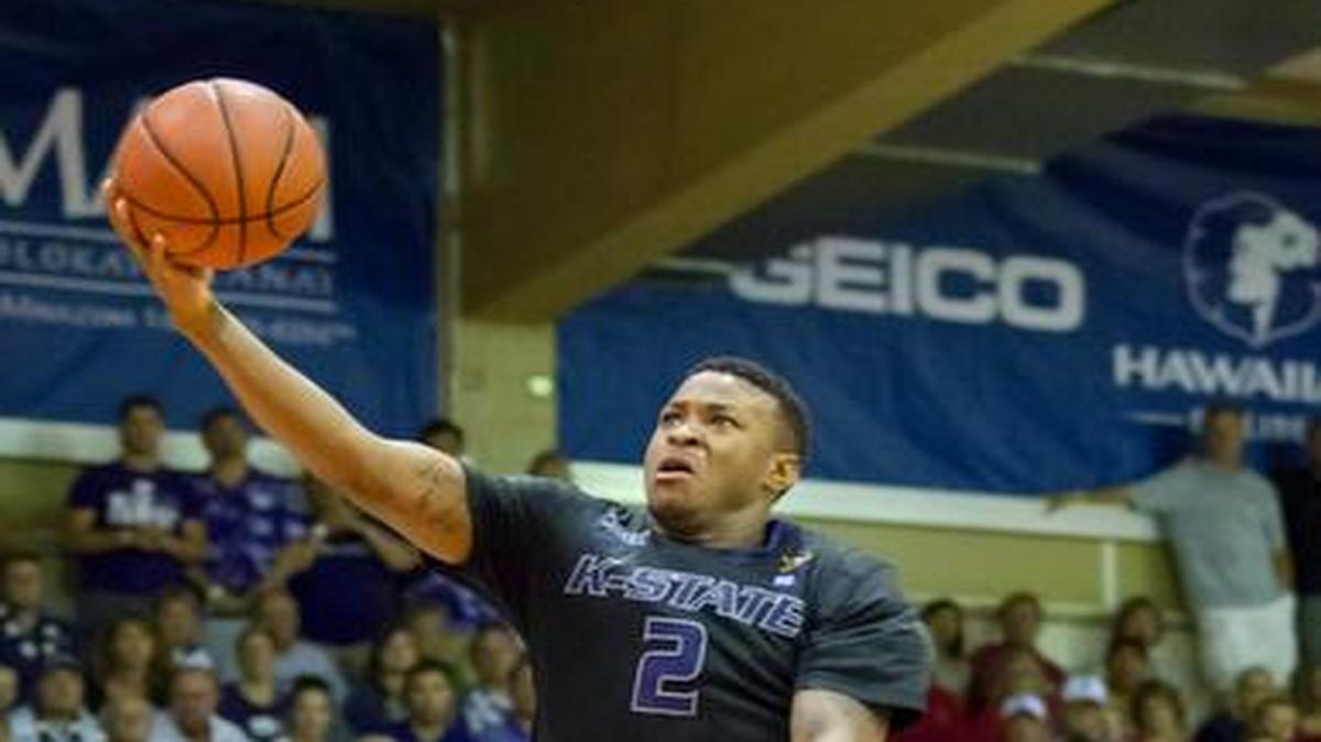 
Kansas State guard Marcus Foster took a shots as Arizona forward Stanley Johnson watched during the Maui Invitational on Tuesday.
