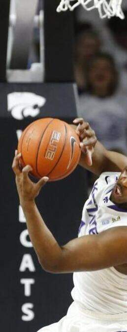 
Kansas State’s Nino Williams (left) and Oklahoma State’s Jeff Newberry fought for a rebound at Bramlage Coliseum in Manhattan, Kan., on Saturday. K-State won 63-53.
