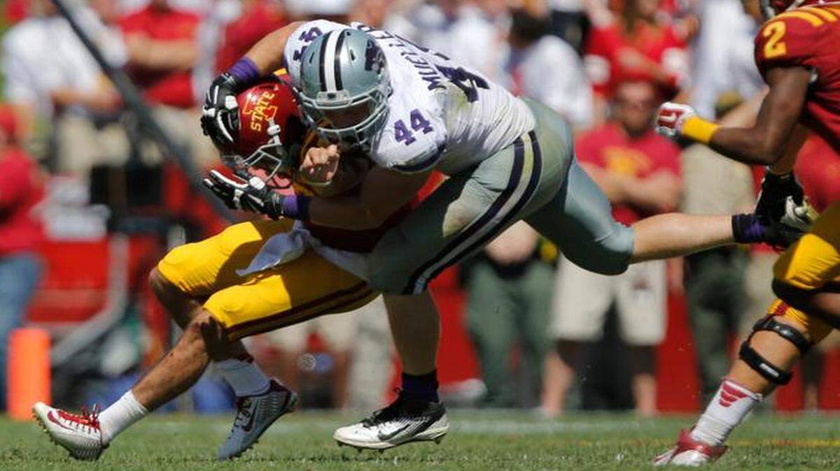 
Kansas State’s Ryan Mueller took down Iowa State quarterback Sam B. Richardson during their game in September.
