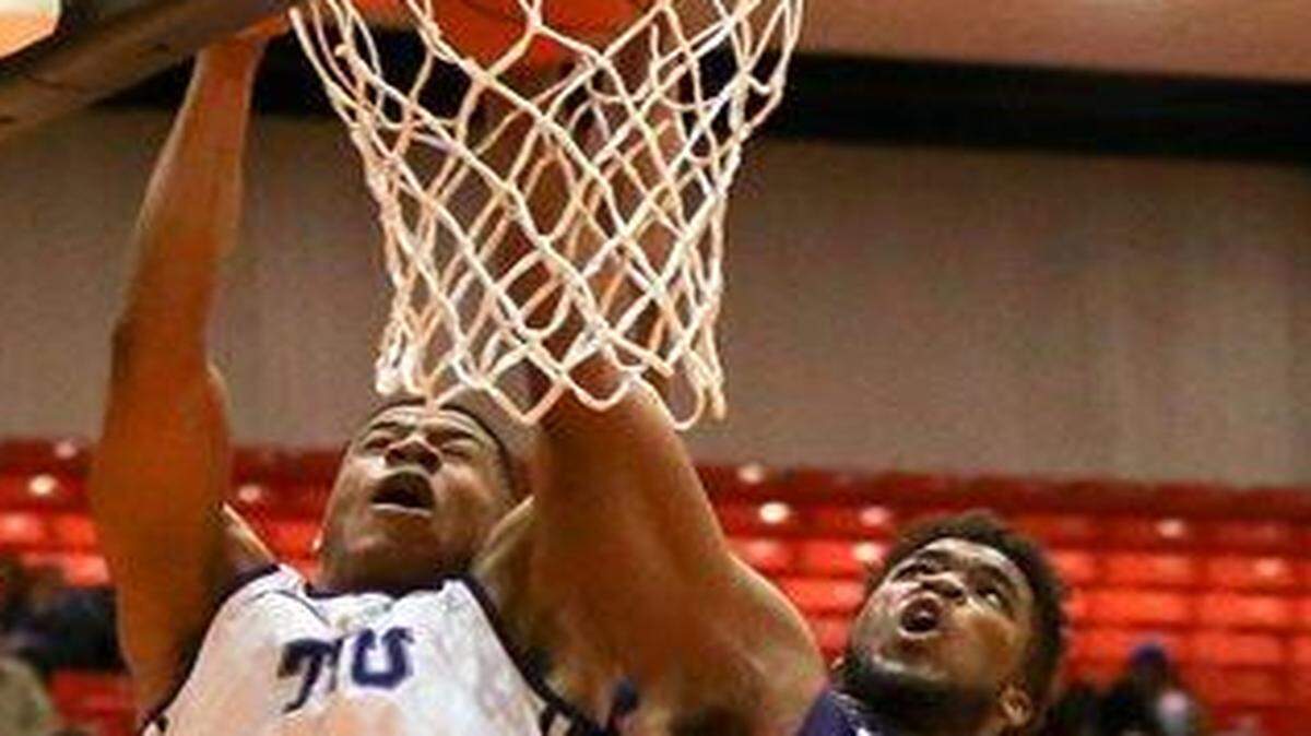 
TCU forward Brandon Parrish slammed the ball through the hoop despite the efforts of Kansas State forward Nino Willams in the second half Wednesday.
