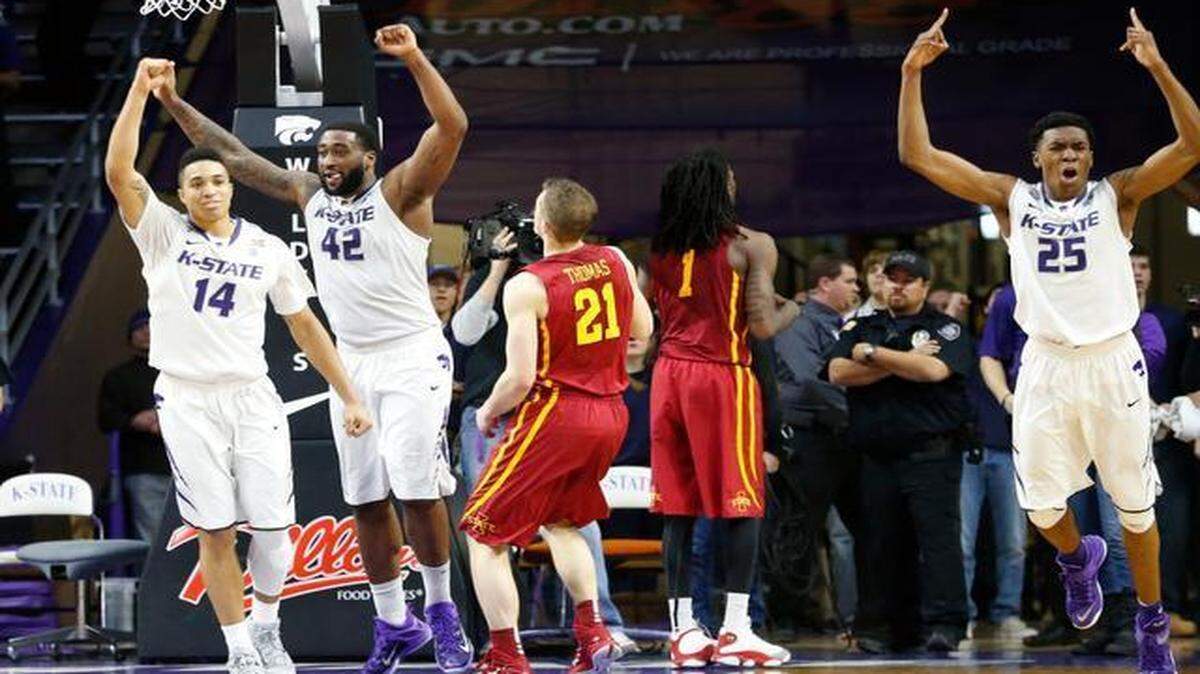 
Kansas State guard Justin Edwards (14), forward Thomas Gipson (42) and guard/forward Wesley Iwundu (25) celebrated as Iowa State guard Matt Thomas’ (21) shot bounced off the rim as time expired Saturday in Manhattan, Kan. The Wildcats beat the Cyclones 70-69.
