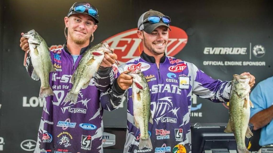 Kyle Alsop of Overland Park (left) and Travis Blenn held up some of the bass they caught Friday as they won the FLW college fishing national championship at Lake Wheeler in Alabama, beating more than 100 teams from 32 states.