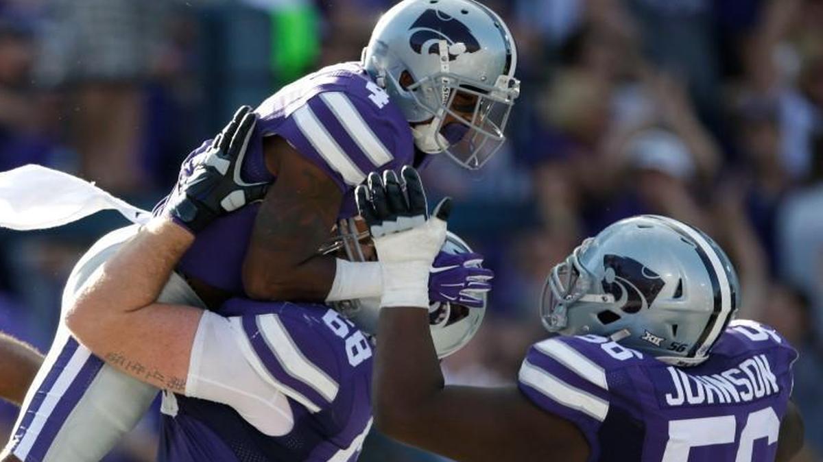 
Terrale Johnson (right) joined Kansas State wide receiver Dominique Heath (left) and Luke Hayes in celebrating an overtime touchdown against Louisiana Tech on Sept. 19. Johnson was a surprise starter this year, but he says he’s feeling more comfortable now.
