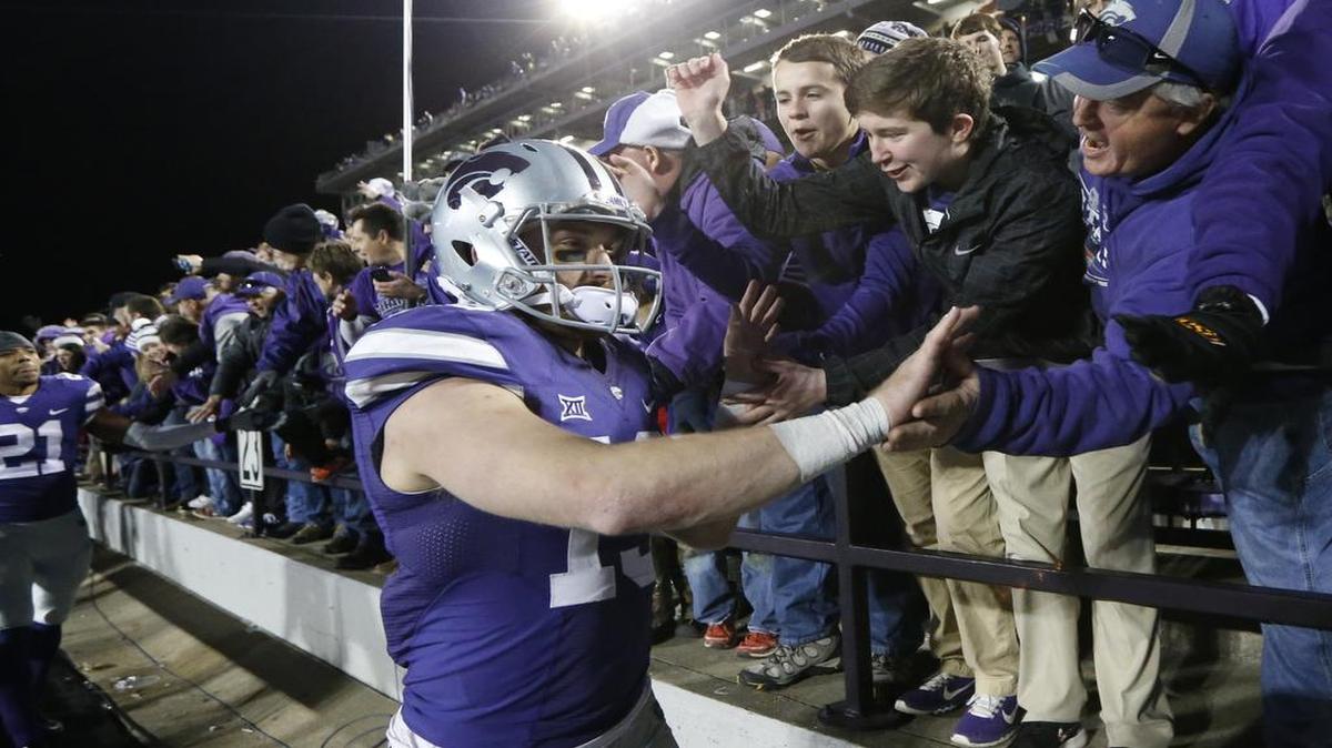 Kansas State quarterback Kody Cook (19) celebrates with fans Saturday after he lead the Wildcats to 2nd half comeback to defeat West Virginia 24-23.