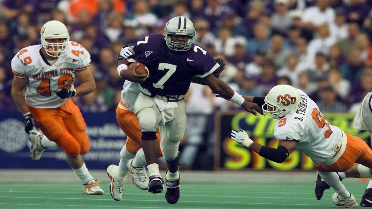
Michael Bishop pushes away Oklahoma State defenders as he runs for 51 yards in the fourth quarter of an October 1998 game.
