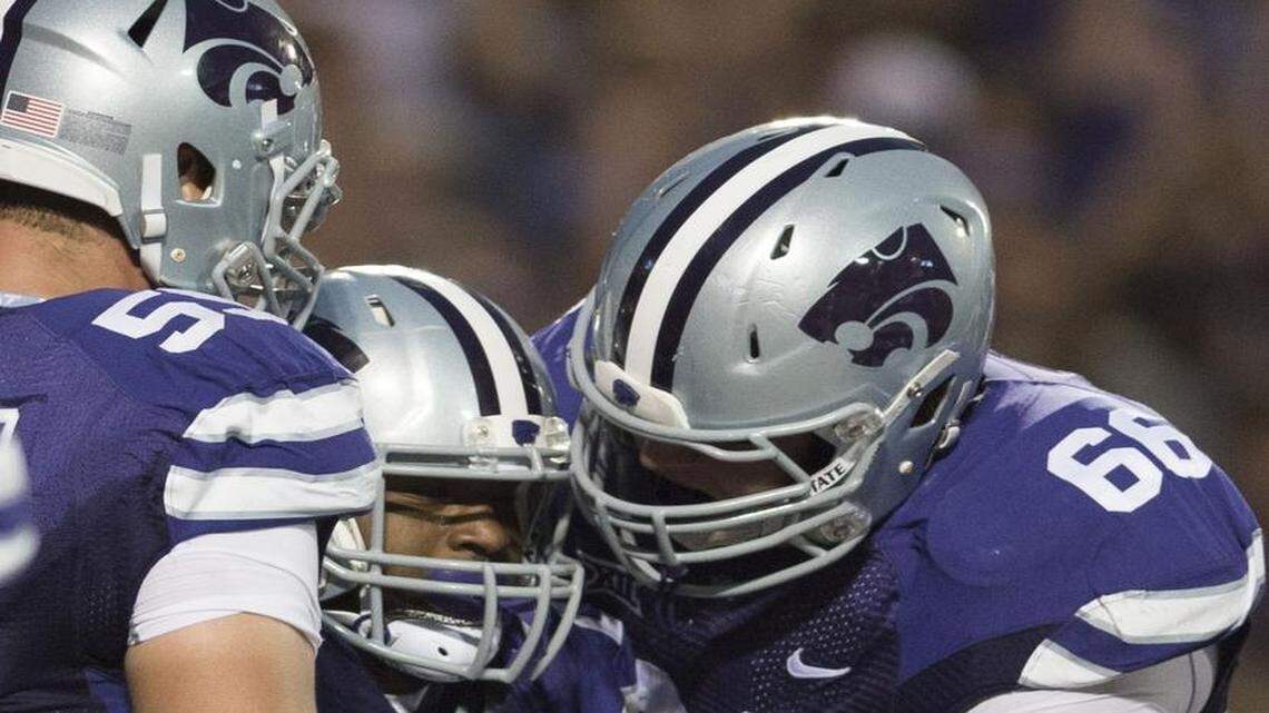 
After a season at left tackle, Kansas State’s Cody Whitehair (from left) is feeling more comfortable in the position. He congratulated running back DeMarcus Robinson with fellow lineman Luke Hayes (68) after a touchdown last year.
