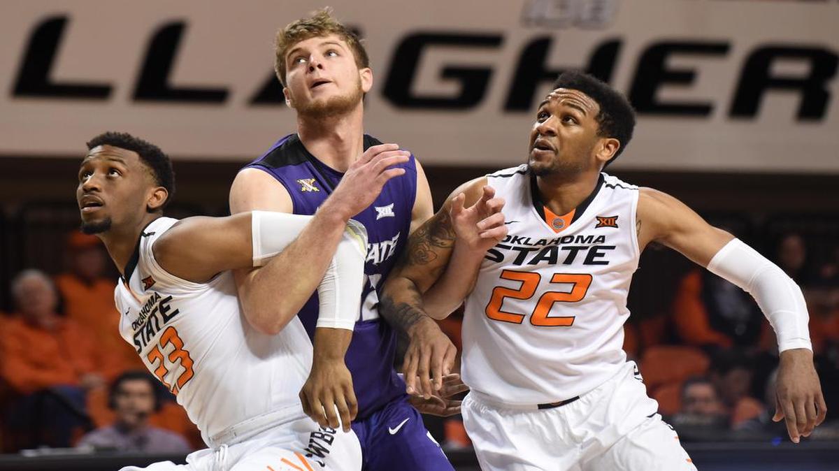 Kansas State forward Dean Wade, center, is blocked by Oklahoma State forward Leyton Hammonds, left, and guard Jeff Newberry in the second half of an NCAA college basketball game in Stillwater, Okla., Saturday, Feb. 13, 2016. Hammonds led Oklahoma State scoring with 13 points in the 58-55 win over Kansas State.
