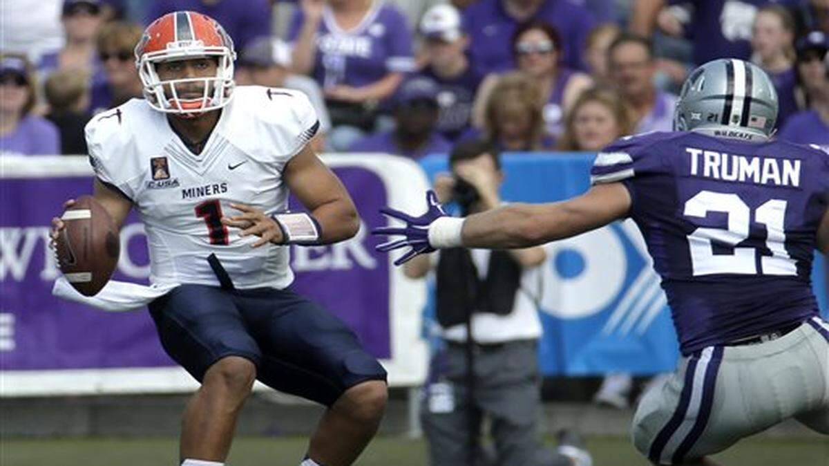 
UTEP quarterback Jameill Showers (left) looks for a receiver as he is pressured by Kansas State linebacker Jonathan Truman in the first half of Saturday’s game in Manhattan, Kan. 
