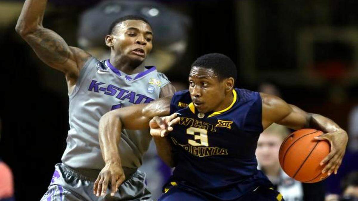 
West Virginia guard Juwan Staten (right) was fouled by Kansas State guard Jevon Thomas on Jan. 27. West Virginia defeated Kansas State 65-59.
