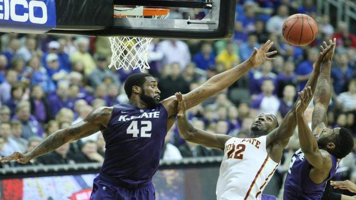 
K-State forward Thomas Gipson reaches for the ball as Iowa State forward Dustin Hogue tries to grab a rebound under the basket during the 2014 Big 12 Tournament. The teams face off with first place on the line Tuesday in Ames, Iowa.
