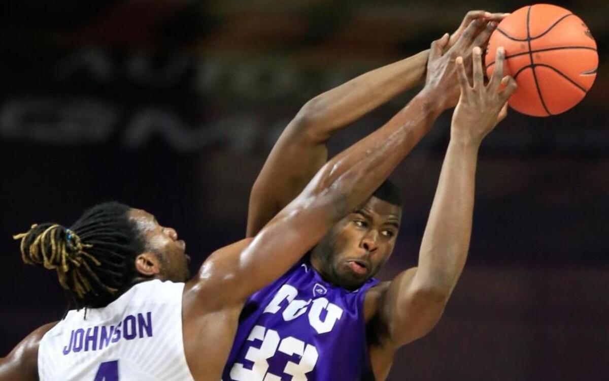 Kansas State forward D.J. Johnson (4) fouled TCU forward Chris Washburn in the second half as the Wildcats and Horned Frogs played Wednesday night in Manhattan, Kan. Kansas State beat TCU 79-54.