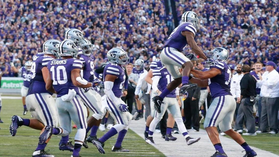 K-State defensive back D.J. Reed leaps while celebrating his interception and touchdown Saturday night against Texas Tech.