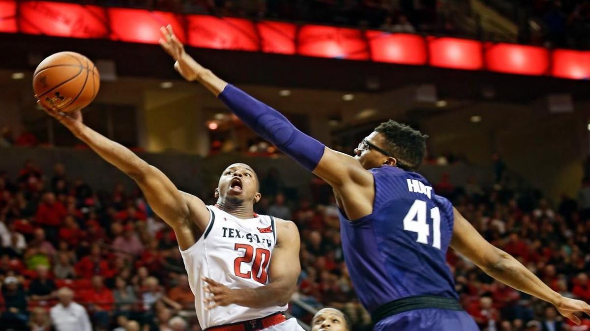 Texas Tech’s Toddrick Gotcher (left) drove for a layup past Kansas State’s Stephen Hurt as the Red Raiders and Wildcats played Saturday in Lubbock, Texas. Texas Tech won 80-71.