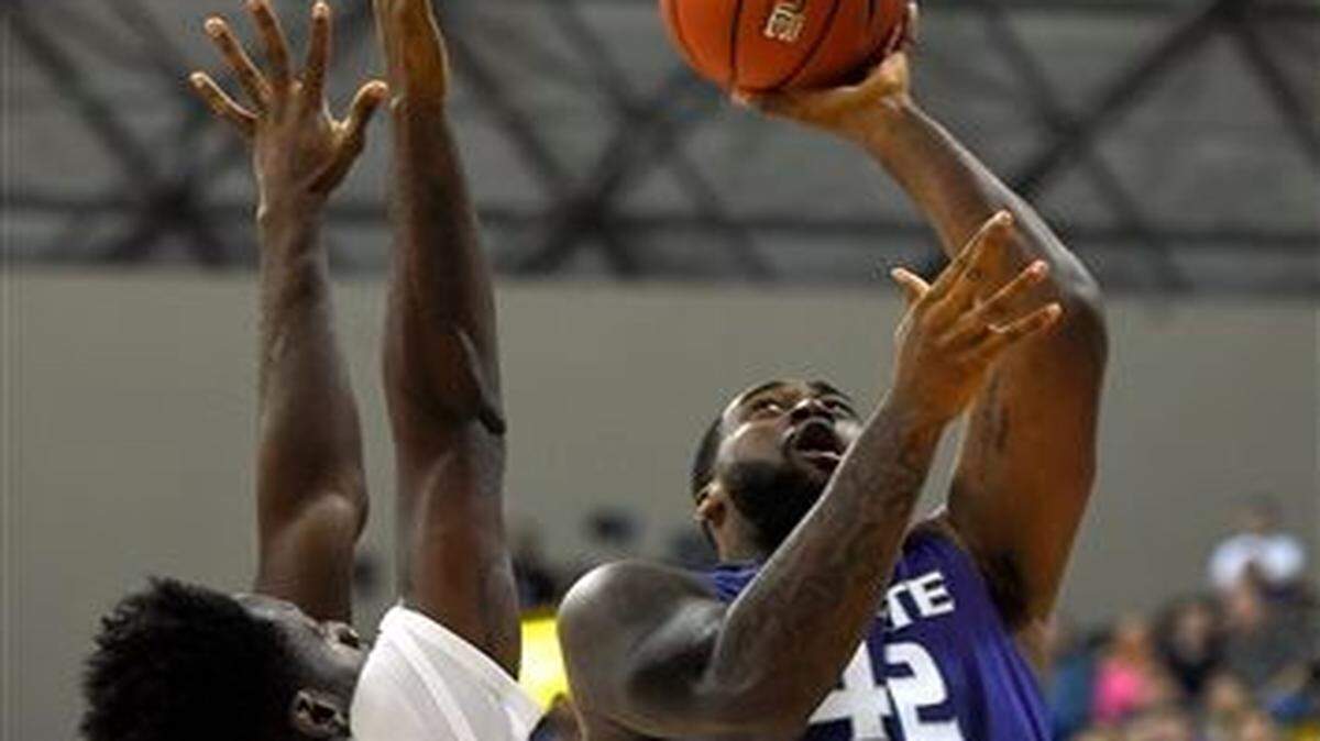 
Kansas State forward Thomas Gipson (right) shoots as Long Beach State forward David Samuels defends during the first half of Friday’s basketball game in Long Beach, Calif.
