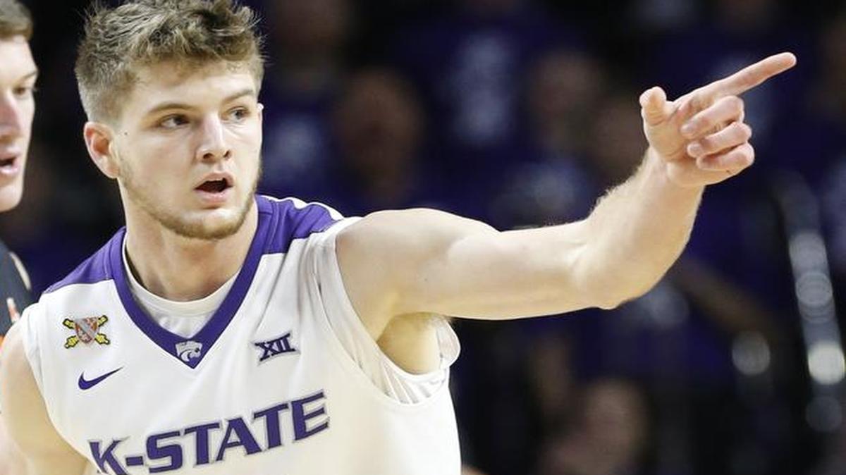 K-State forward Dean Wade points to the bench after shooting a three-point shot against Oklahoma State last month.