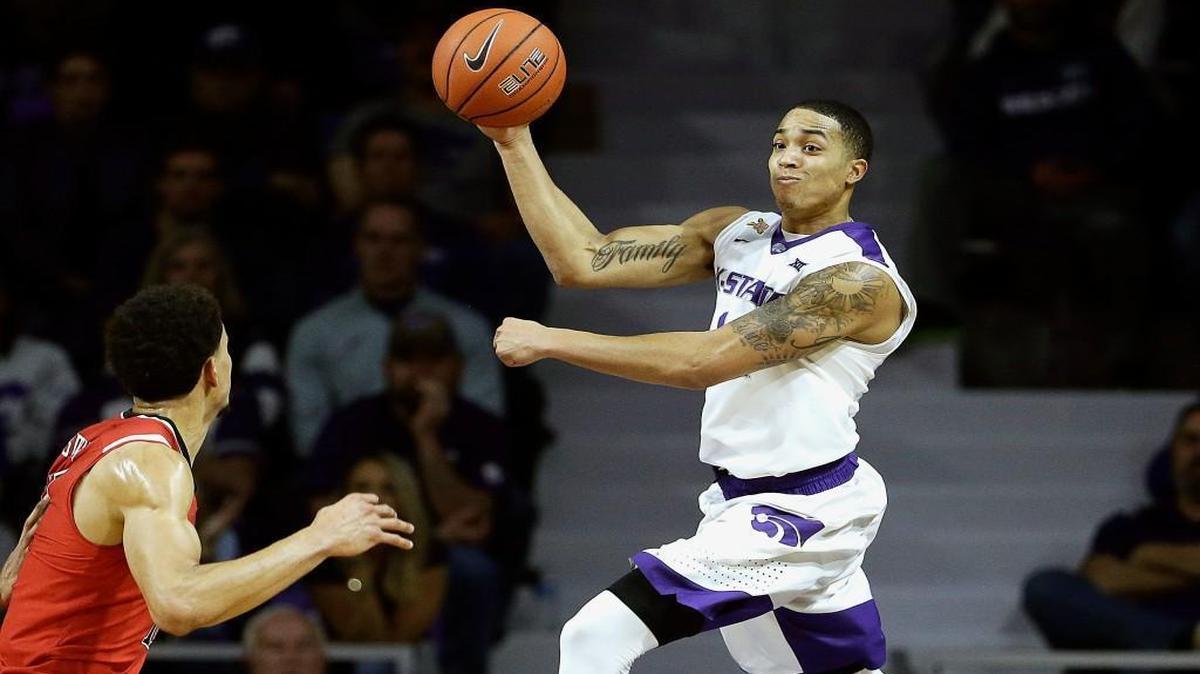 Kansas State’s Justin Edwards threw the ball over the head of Texas Tech’s Zach Smith as he kept the ball from going out of bounds in the first half as the Wildcats and Red Raiders played Tuesday night in Manhattan, Kan.