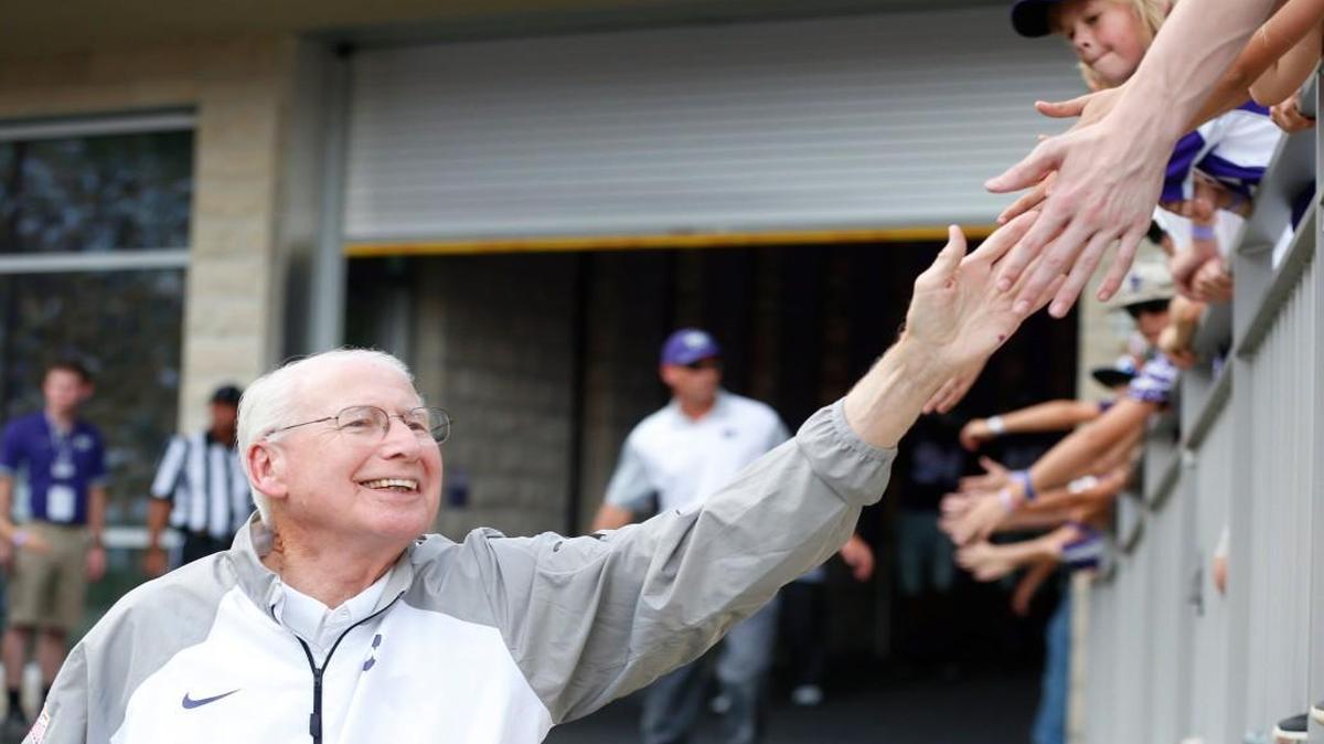 K-State head coach Bill Snyder "high fives" young fans on this way to the field. (September 05, 2015)
