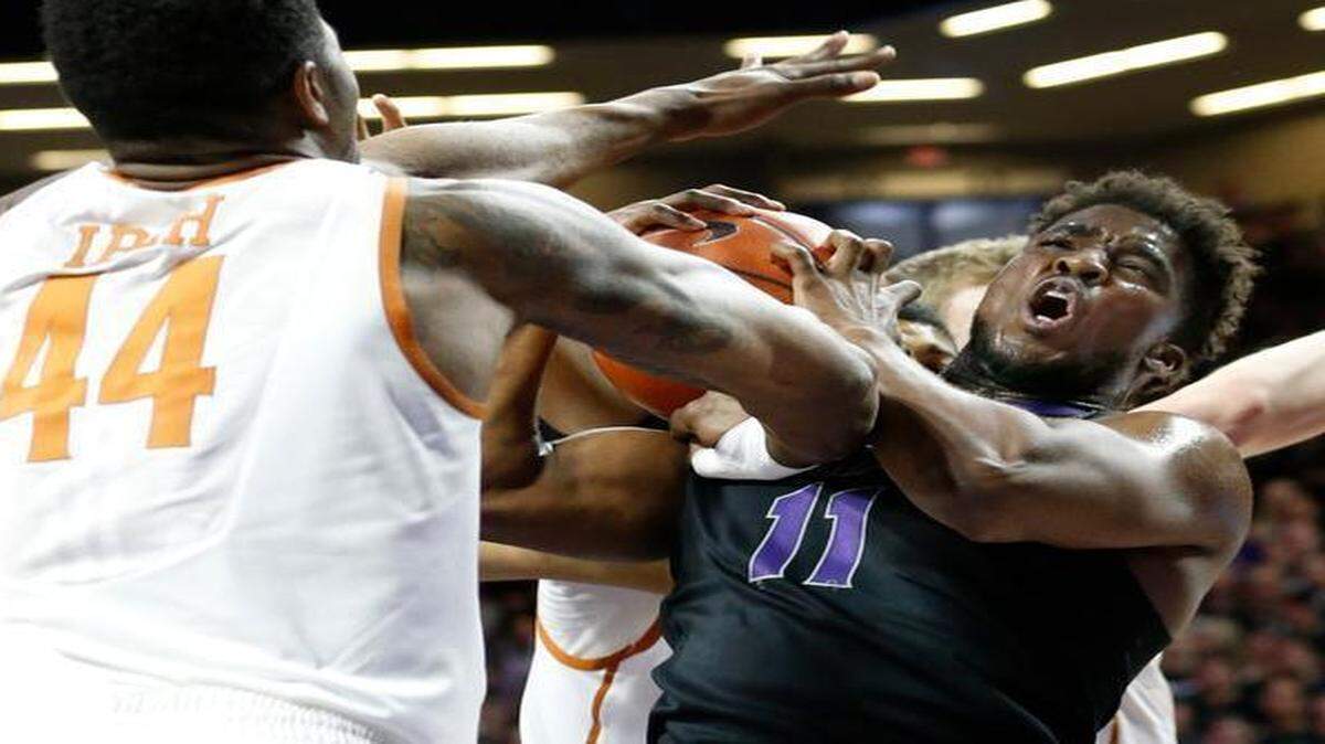 
K-State forward Nino Williams and Texas center Prince Ibeh battle for a rebound in Manhattan. Texas won 61-57 on Feb. 7.
