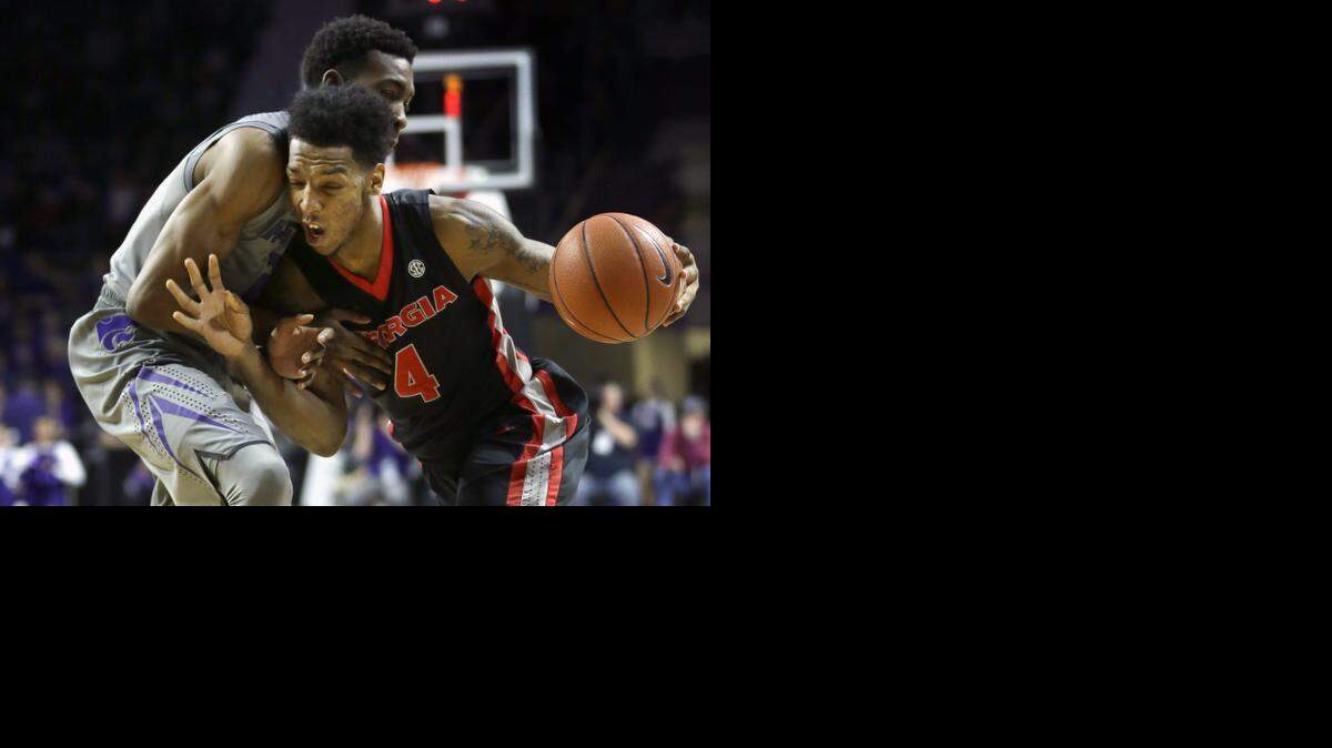 
Georgia guard Charles Mann was fouled by Kansas State guard Wesley Iwundu as he tried to drive to the basket during the first half Wednesday in Manhattan, Kan.
