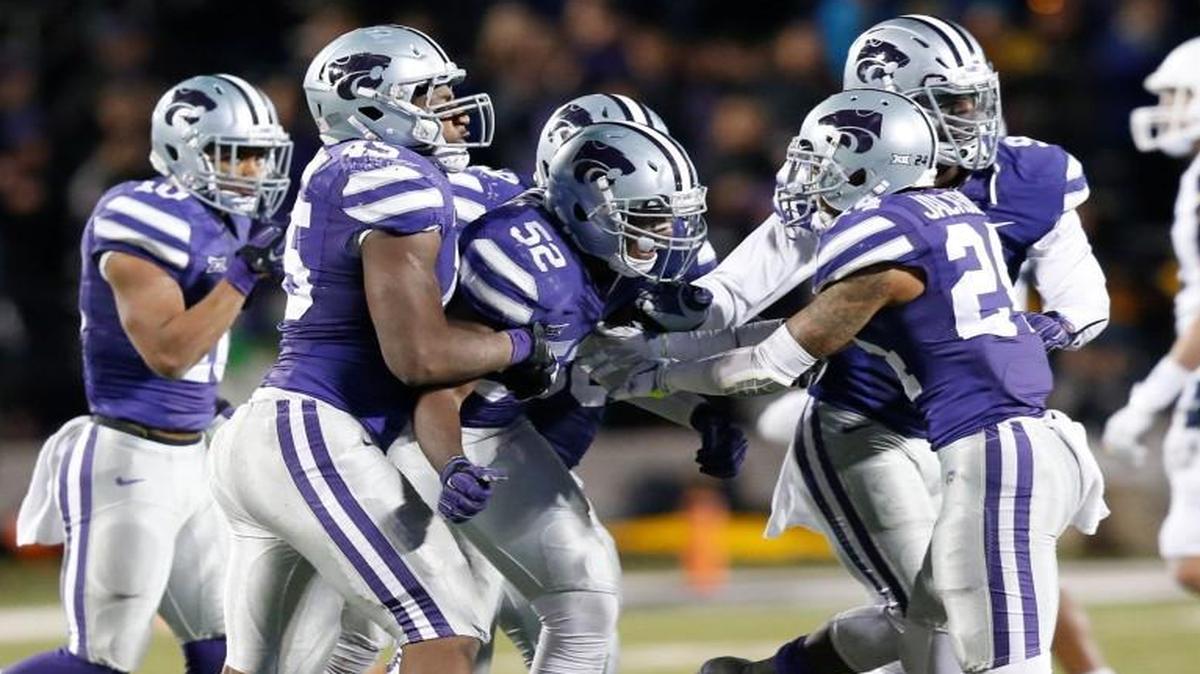 Kansas State defenders celebrated with linebacker Charmeachealle Moore (52) after he sacked West Virginia quarterback Skyler Howard in the Wildcats’ Dec. 5 victory.