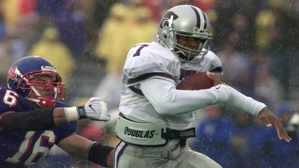Kansas State quarterback Michael Bishop evaded the grasp of Kansas linebacker Tim Bowers in the second quarter as Bishop carries the ball down to the 1-yard line during an Oct. 31, 1998, game in Lawrence.