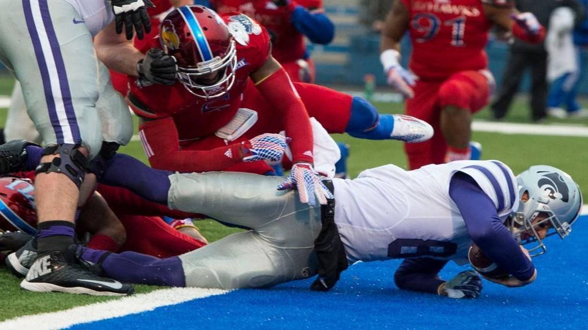 Kansas linebacker Marcquis Roberts (5) and Kansas safety Fish Smithson (9) couldn’t keep Kansas State quarterback Joe Hubener (8) out of the end zone as he scored in the second quarter of the Sunflower Showdown football game Saturday in Lawrence.