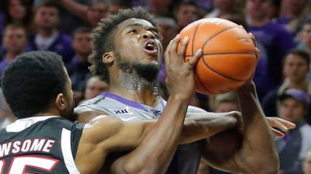 
Kansas State's Nino Williams is fouled by Nebraska-Omaha's Devin Newsome during the first half on Tuesday night at Bramlage Coliseum in Manhattan. Teammate C.J. Carter gets in on the play.
