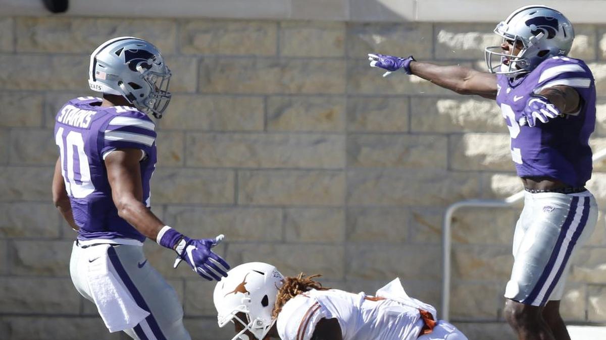 K-State’s D.J. Reed (right) and Donnie Starks celebrated after Reed knocked away a long pass to Texas’ Armanti Foreman last Saturday in Manhattan, Kan.