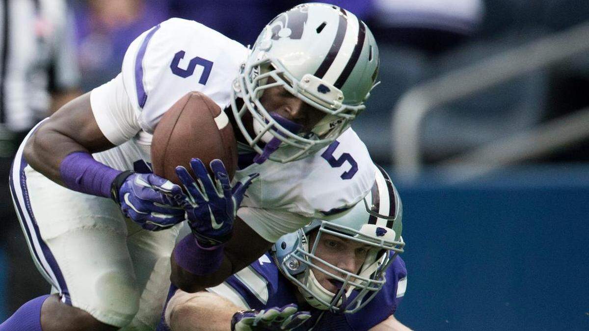 
Kansas State defensive back Jesse Mack (5) picked off a pass intended Wildcats wide receiver Kyle Klein (81) and returned it for a touchdown in the first quarter of K-State’s spring game Saturday at Sporting Park, which hosted the game while Bill Snyder Family Stadium in Manhattan undergoes renovations.
