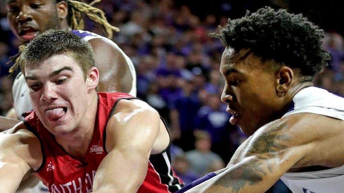 Kansas State’s Wesley Iwundu (right) and South Dakota’s Dan Jech battled for a loose ball in Friday’s game.
