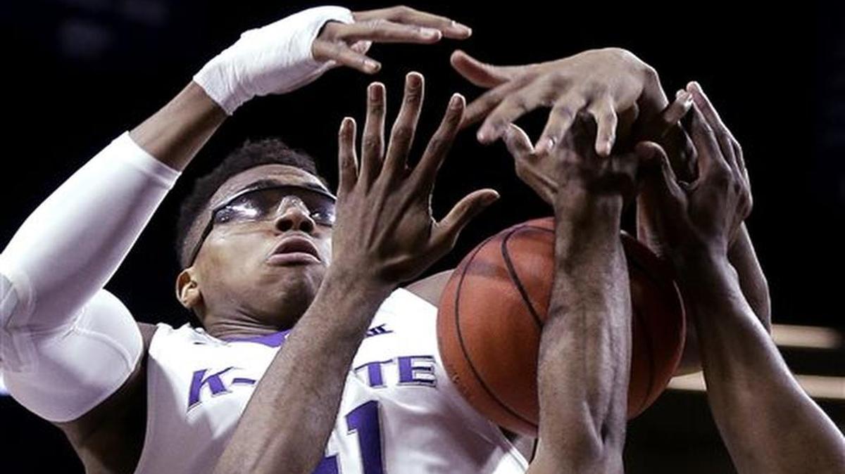 Kansas State's Stephen Hurt battles a pair of Coppin State players for a rebound during the first half of an NCAA college basketball game, Wednesday, Dec. 9, 2015, in Manhattan, Kan. (AP Photo/Charlie Riedel)