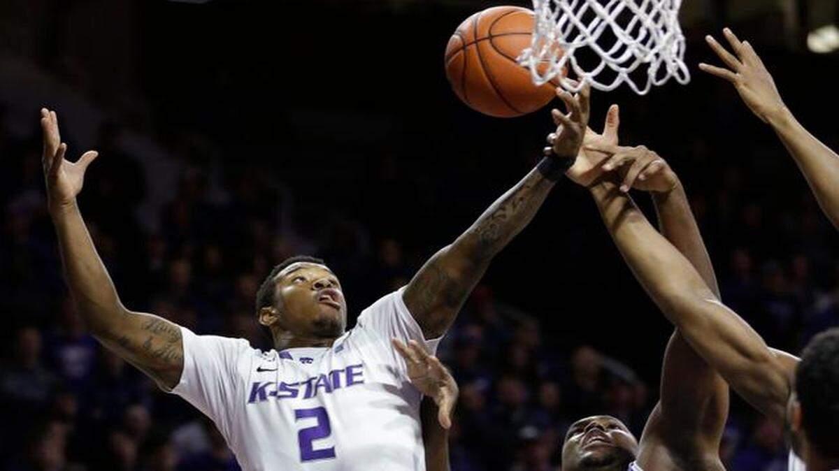 
Kansas State guard Marcus Foster rebounds against TCU forward Devonta Abron during the Wildcats’ victory Wednesday night in Manhattan.
