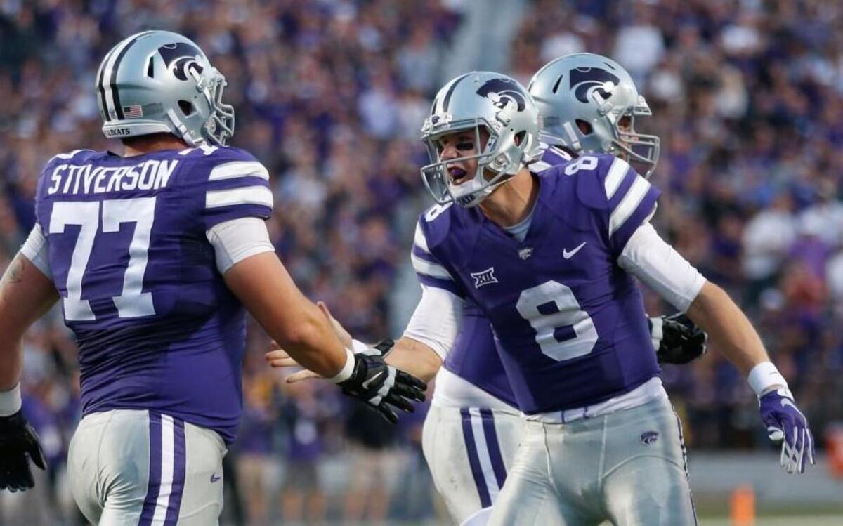 K-State quarterback Joe Hubener celebrates with K-State offensive lineman Boston Stiverson after Hubener scored a touchdown in the first quarter. (October 10, 2015)