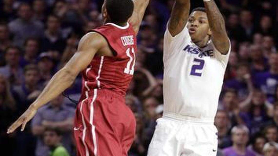 Kansas State guard Marcus Foster (2) shoots the go-ahead basket over Oklahoma guard Isaiah Cousins (11) during the second half of an NCAA college basketball game at Bramlage Coliseum in Manhattan, Kan., Saturday, Feb. 14, 2015. Kansas State defeated Oklahoma 59-56.