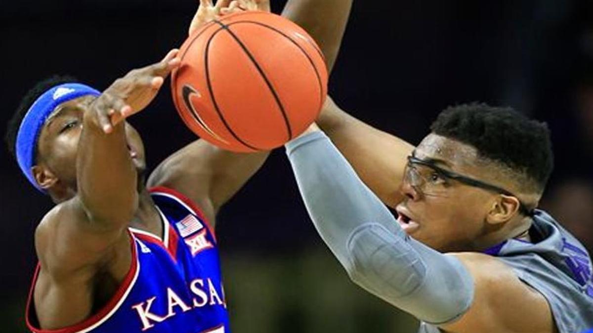 Kansas State’s Stephen Hurt (right) had the ball knocked away from him by Kansas’ Carlton Bragg Jr. in the first half of Saturday’s game.