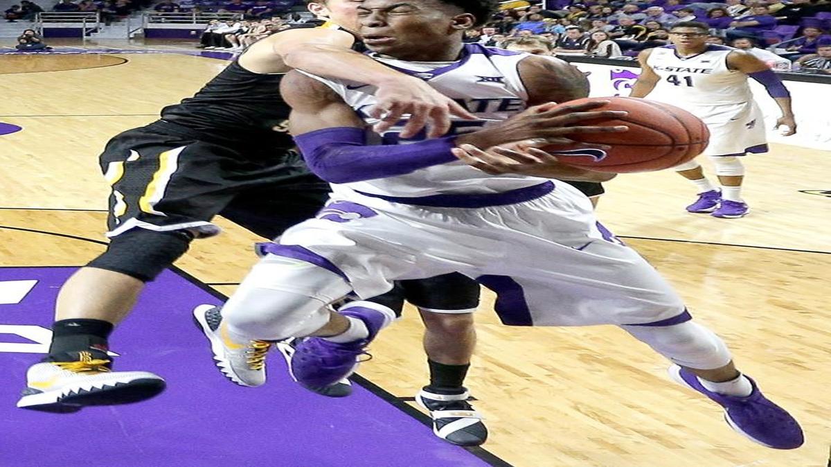 K-State’s Wesley Iwundu absorbed a hit from Fort Hays State’s Hadley Gillum in the second half.
