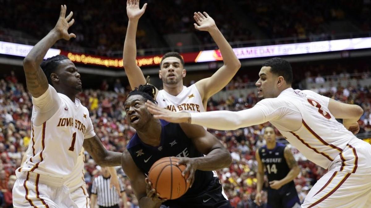 Kansas State forward D.J. Johnson was ready to take it up against Iowa State defenders on Saturday in Ames, Iowa.