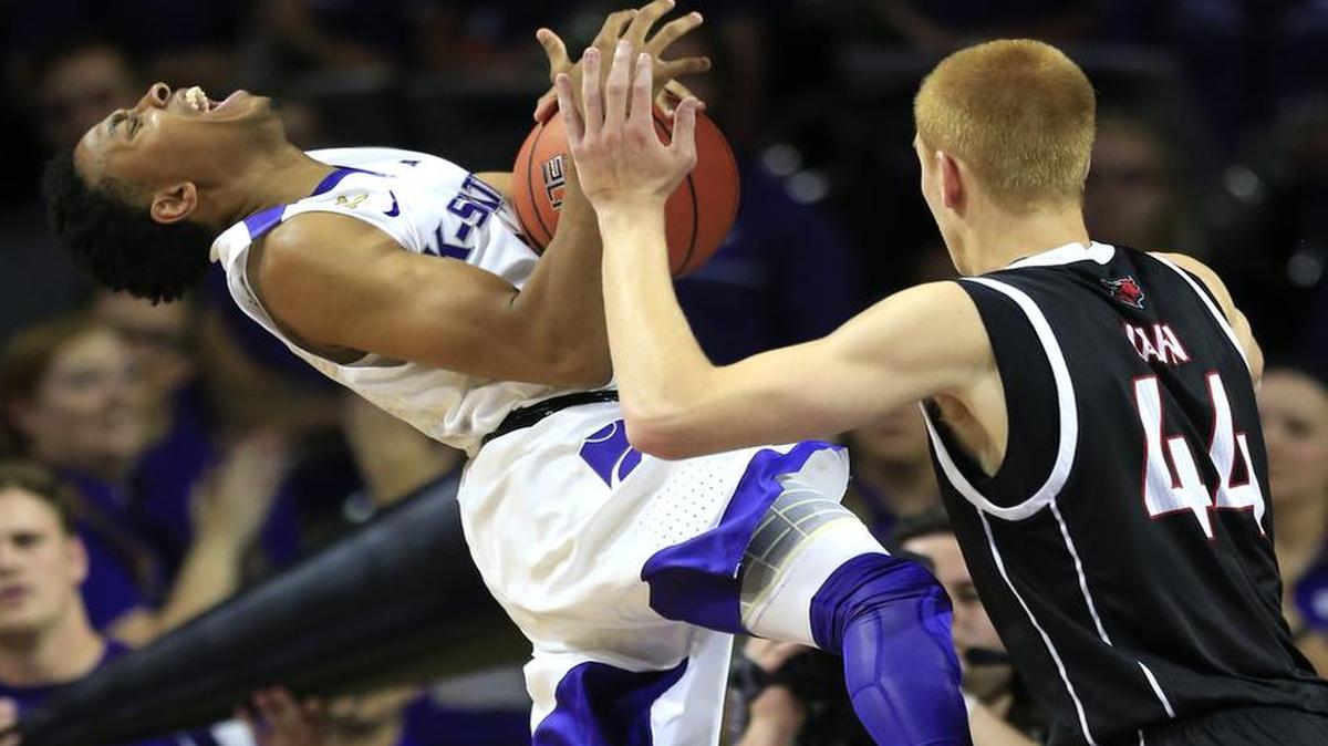 Kansas State guard Kamau Stokes (left) is fouled by Omaha forward Mitchell Hahn during the first half of Tuesday’s game in Manhattan, Kan.