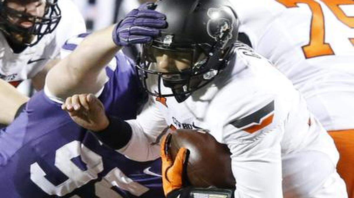 
K-State defensive lineman Travis Britz (95) sacks Oklahoma State quarterback Daxx Garman (12) for a loss in the 2nd quarter. (November 1, 2014)
