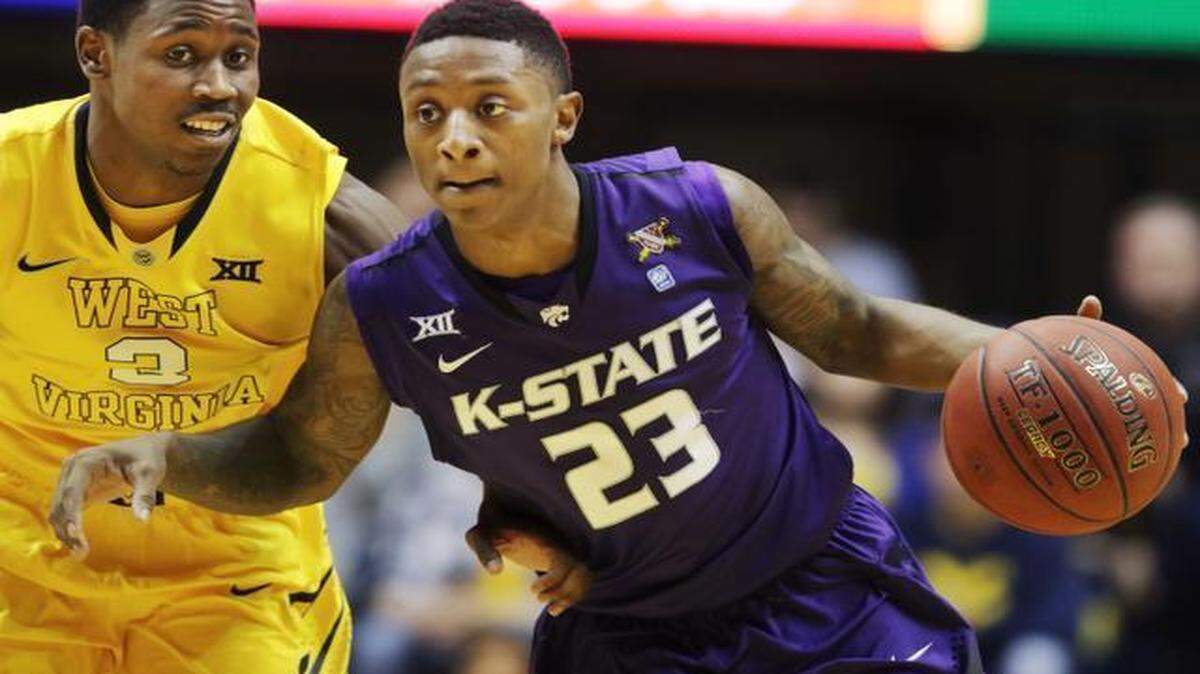 
Kansas State guard Nigel Johnson (23) drove upcourt while being defended by West Virginia guard Juwan Staten (3) in the first half Wednesday night in Morgantown, W.Va.
