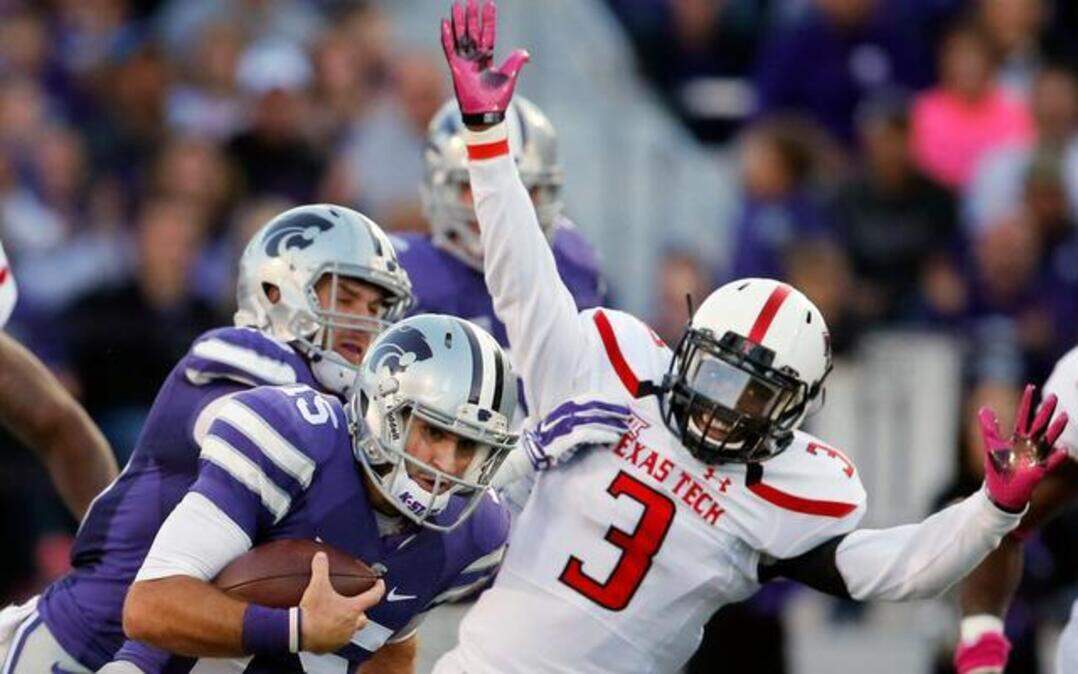 
Kansas State quarterback Jake Waters (15) ran past Texas Tech defensive back J.J. Gaines (3) in the first half Saturday in Manhattan, Kan.
