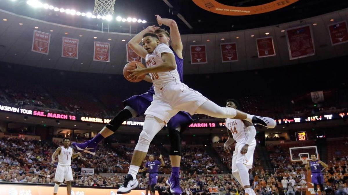 Texas guard Eric Davis Jr. (10) pulled down a rebound in front of Kansas State forward Dean Wade (32) in the first half Tuesday night in Austin, Texas.