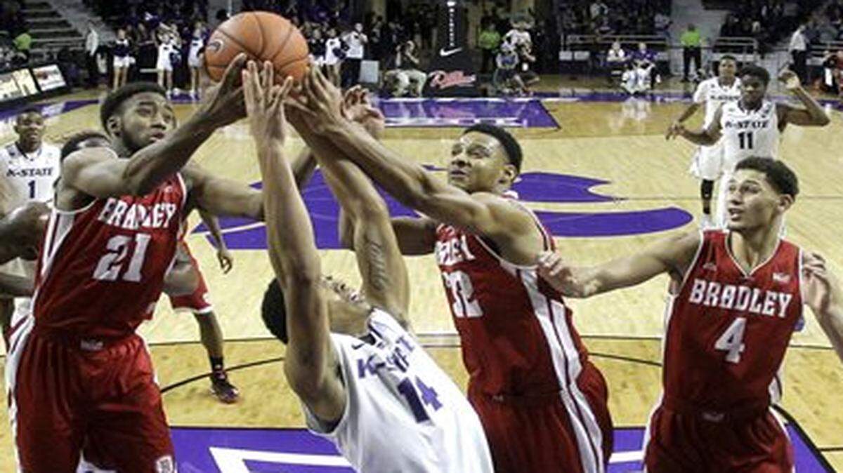 
Kansas State’s Justin Edwards (center) battled Bradley’s Josh Cunningham (left), Mike Shaw and Auston Barnes (right) for a rebound during the second half of Tuesday’s game.
