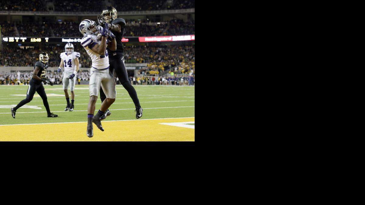 
Kansas State wide receiver Tyler Lockett (16) grabs a touchdown pass in front of Baylor cornerback Ryan Reid, right, in the second half of an NCAA college football game, Saturday, Dec. 6, 2014, in Waco, Texas. Baylor won 38-27. 
